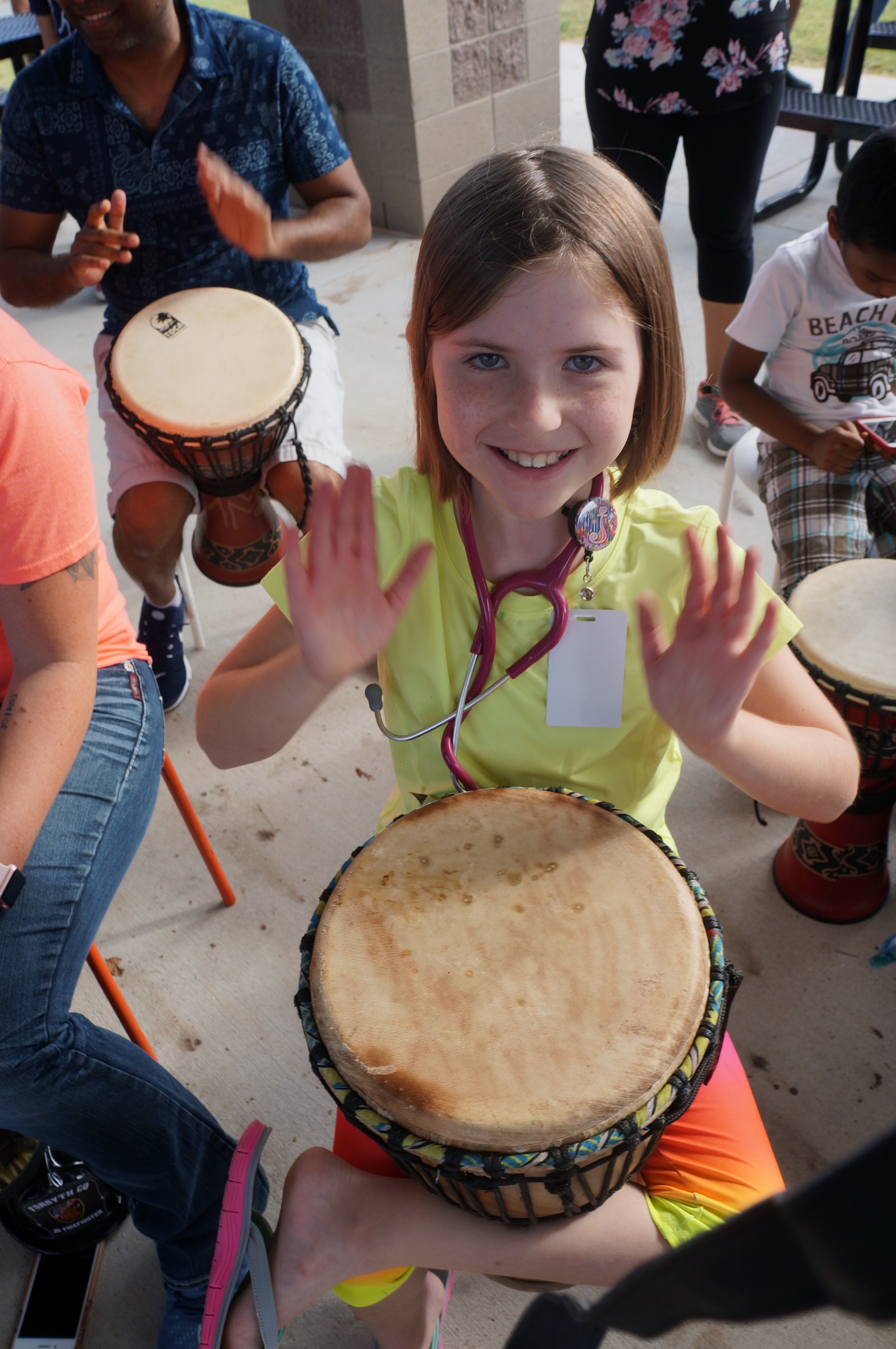 All-ages enjoy our drum circle Fam Jams.